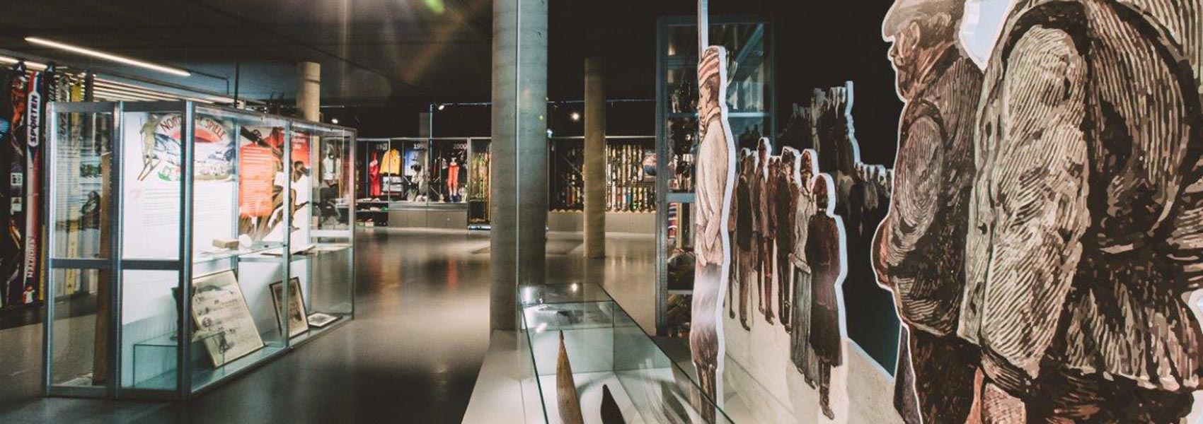 Ausstellung Wintersportmuseum_linke Seite Vitrine_rechte Seite alte Skifahrer (Figuren)